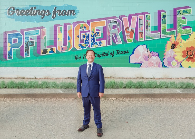 Jonathan Coffman in Pflugerville in front of the West Pecan mural