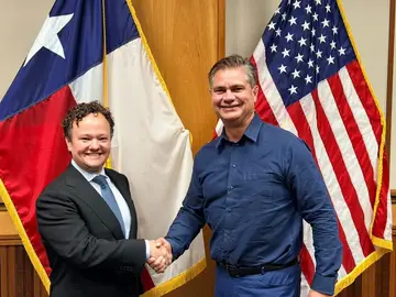 Jonathan Coffman shaking hands with a local leader at City Hall