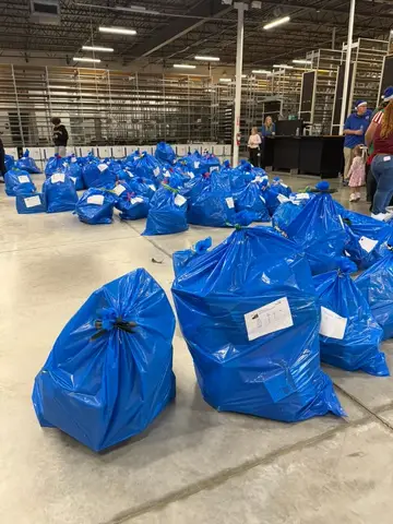 Blue Santa gift bags prepared for Pflugerville families