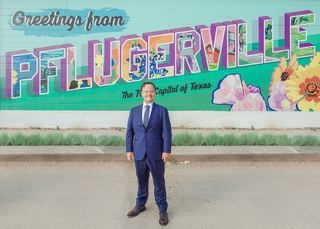 Jonathan Coffman in Pflugerville in front of the West Pecan mural