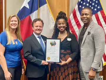 Jonathan Coffman with local leaders holding a certificate at City Hall
