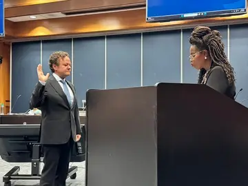 Jonathan Coffman taking the oath of office at the Pflugerville council dais