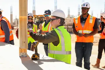 Jonathan Coffman signing a beam at The Monarch recreation center construction site