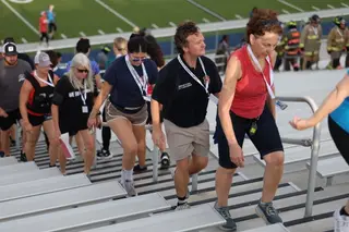 Jonathan Coffman climbing the stadium stairs with Pflugerville residents during the September 11 memorial stair climb