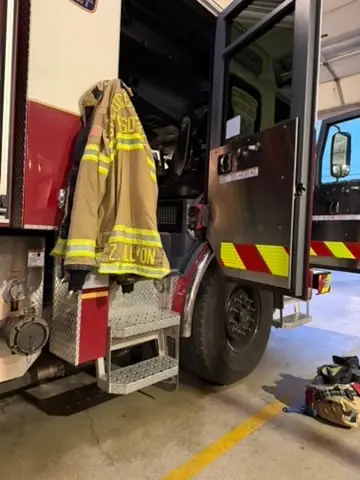 A Pflugerville firefighter coat hanging on a fire truck