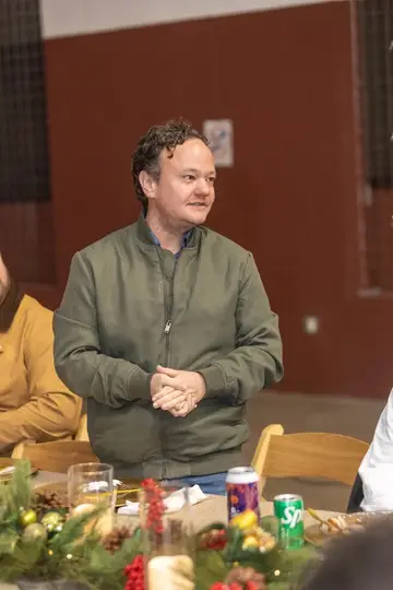 Jonathan Coffman speaking with residents around a holiday table