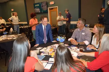 Jonathan Coffman speaking with local business owners at a roundtable
