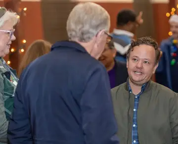 Jonathan Coffman listening to residents at a holiday event