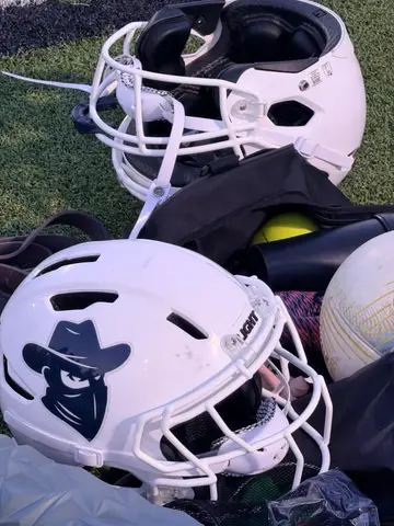 Youth football helmets and equipment on the field