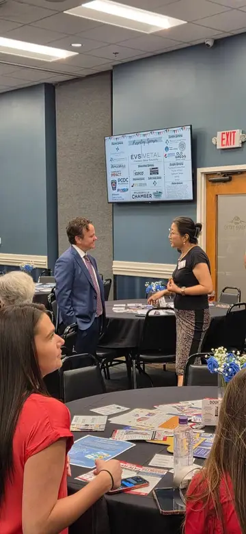 Jonathan Coffman speaking one-on-one with a resident at a business event