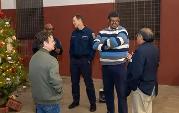Jonathan Coffman speaking with residents at a holiday community event
