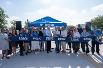 Jonathan Coffman and community leaders cutting the ribbon for the PCDC-funded Helios Way extension