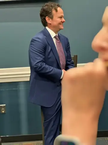 Jonathan Coffman smiling while speaking with residents at a local business event