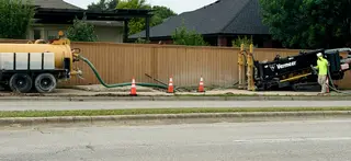 Fiber construction equipment using a lower-disruption boring method beside a sidewalk